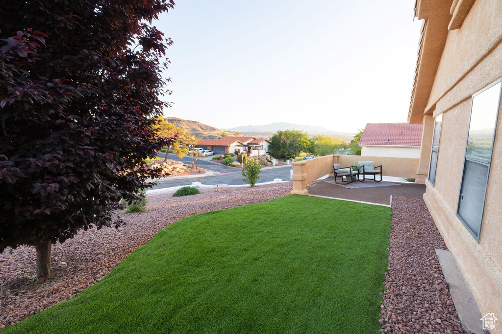 View of yard featuring a patio, an outdoor living space, and a mountain view