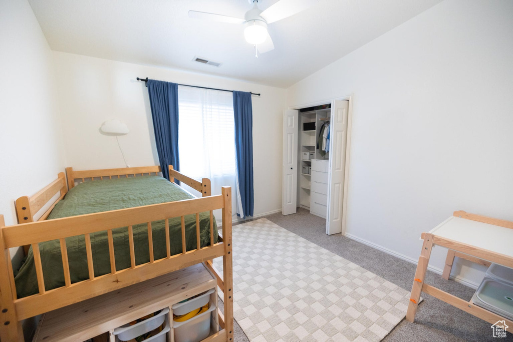 Bedroom featuring ceiling fan, carpet, baseboards, vaulted ceiling, and visible vents