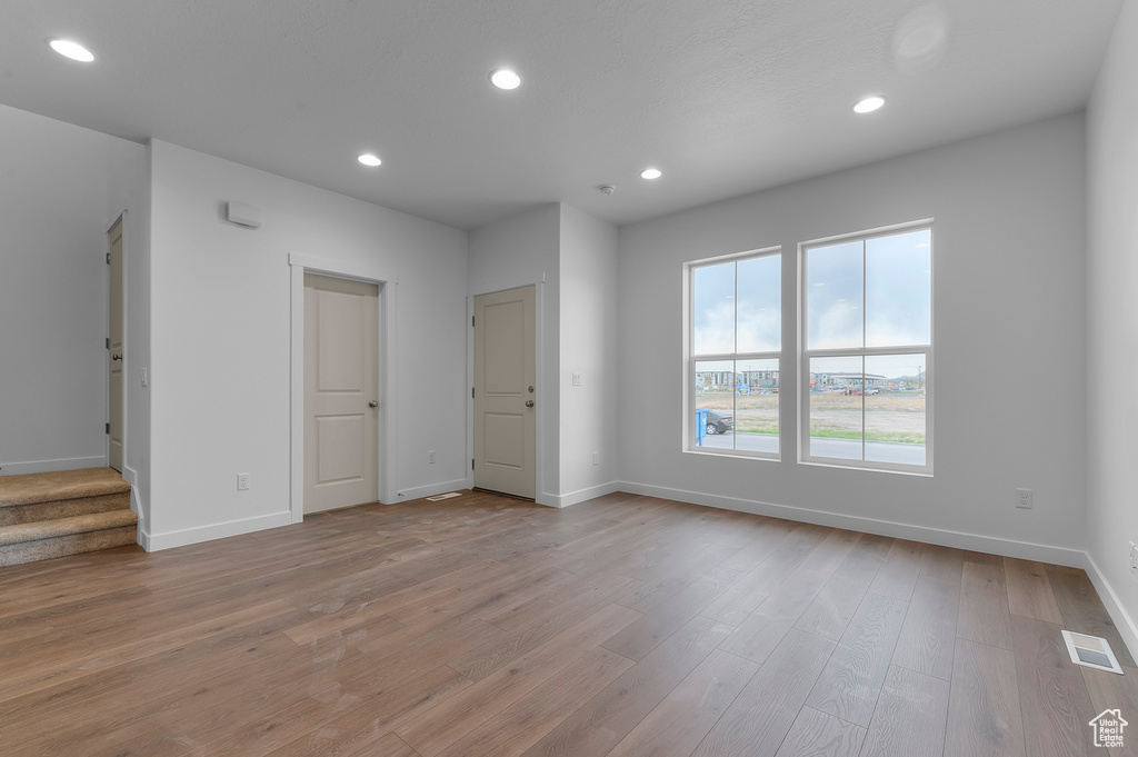 Spare room featuring recessed lighting, baseboards, visible vents, and light wood-style floors
