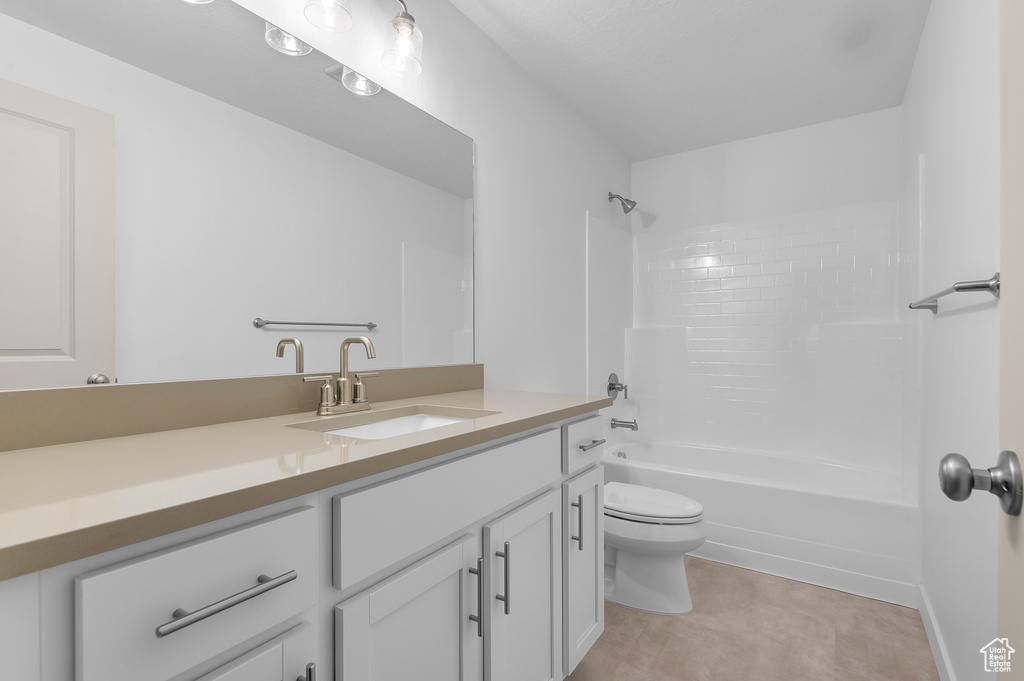 Bathroom featuring vanity, shower / bathtub combination, and toilet
