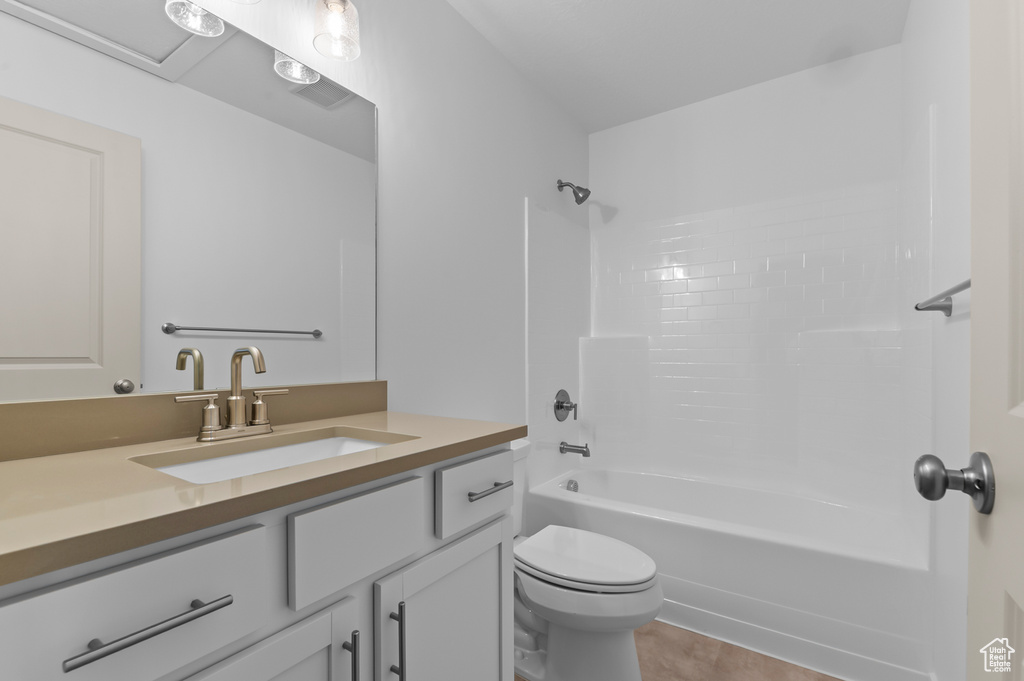 Full bathroom featuring vanity, shower / bathing tub combination, toilet, and tile patterned flooring
