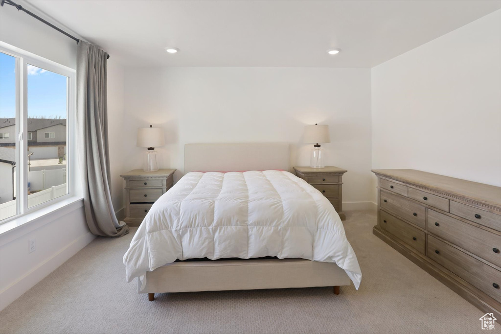 Bedroom with recessed lighting, baseboards, and light carpet
