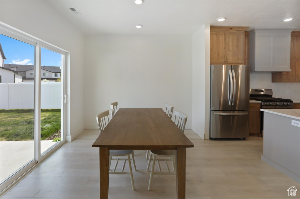 Dining room with recessed lighting, light wood-style flooring, and visible vents