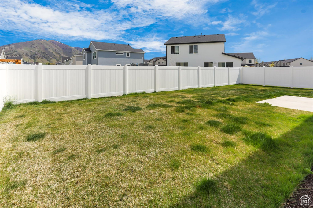 View of yard featuring a fenced backyard, a patio area, and a residential view