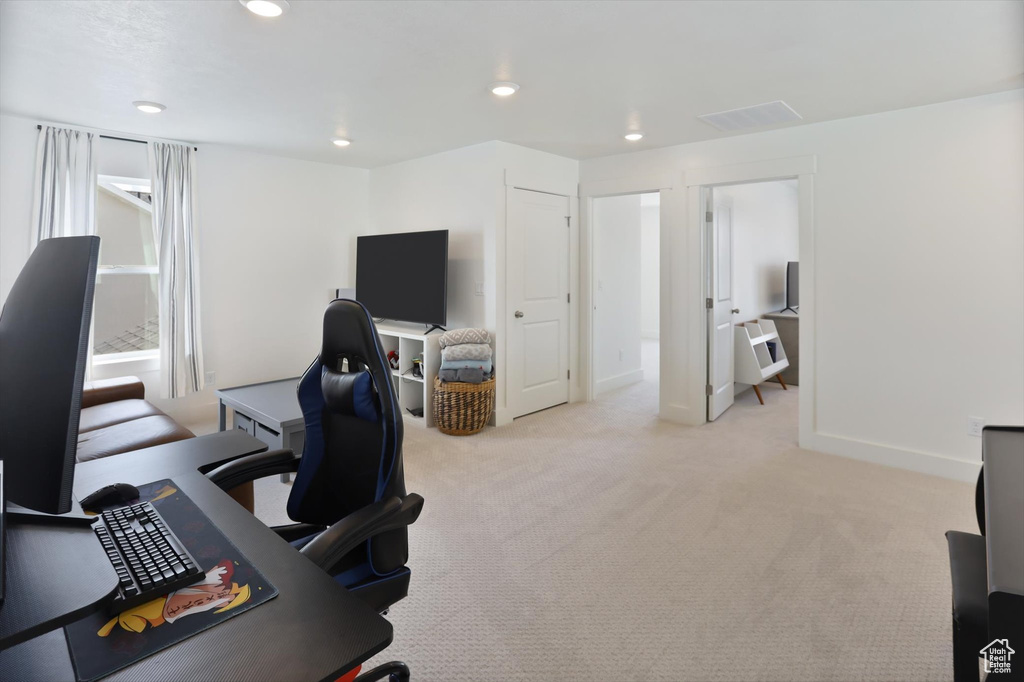 Home office with recessed lighting, baseboards, visible vents, and light carpet