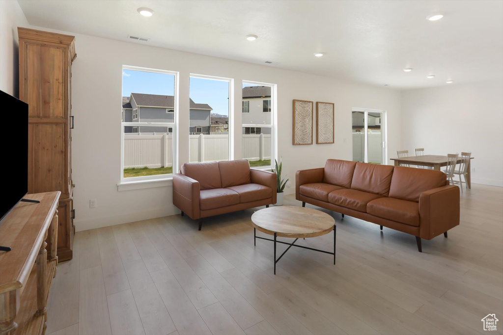 Living area with visible vents, recessed lighting, and light wood-type flooring