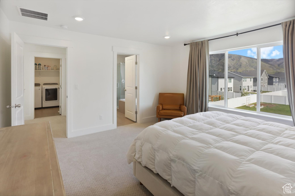 Bedroom with visible vents, washer and dryer, light carpet, baseboards, and recessed lighting