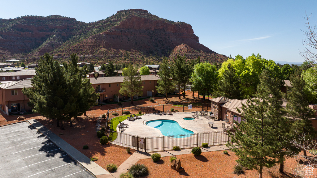 Community pool with a patio area and a mountain view