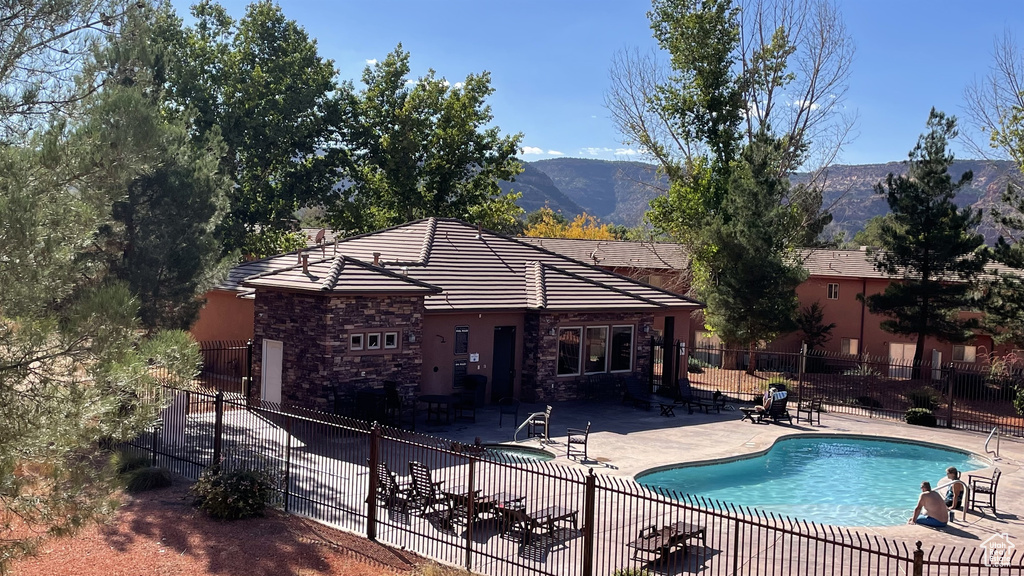 View of swimming pool with a patio, fence, and a fenced in pool