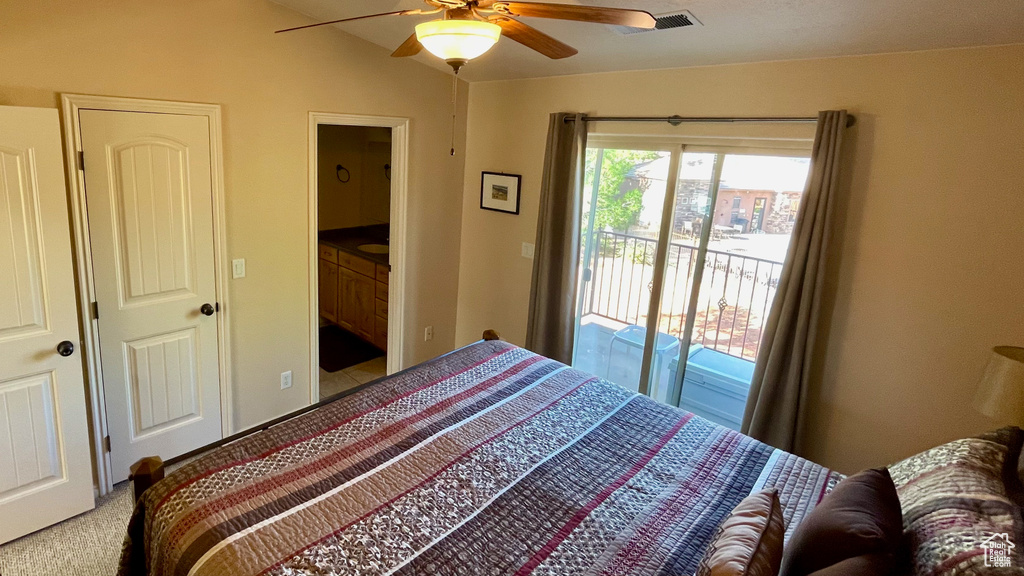 Bedroom featuring a ceiling fan, visible vents, light colored carpet, access to exterior, and lofted ceiling