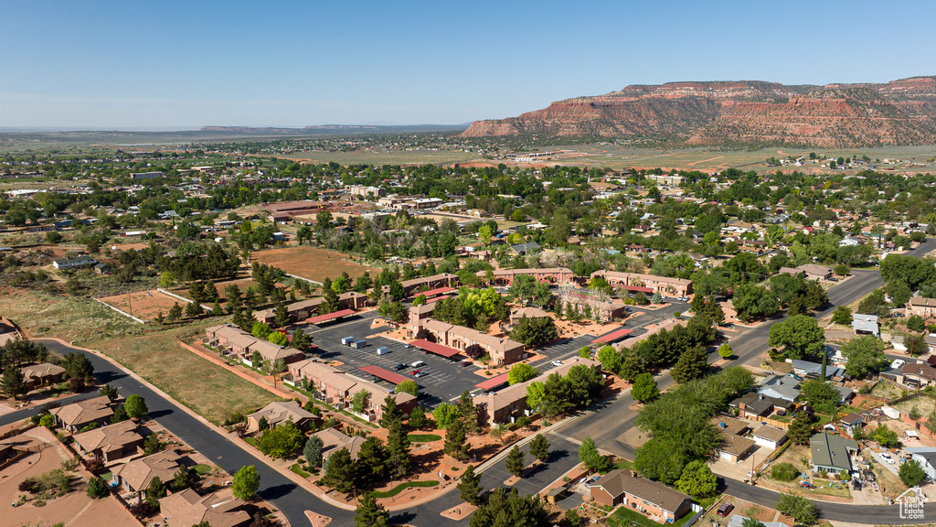 Aerial view of property and surrounding area with a mountain backdrop
