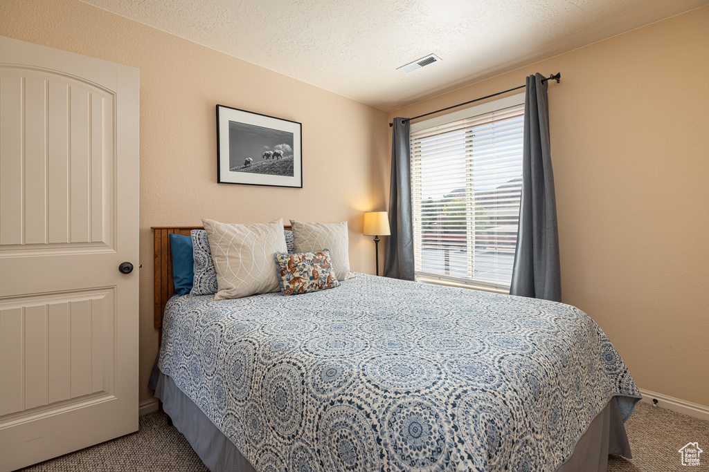 Carpeted bedroom with baseboards