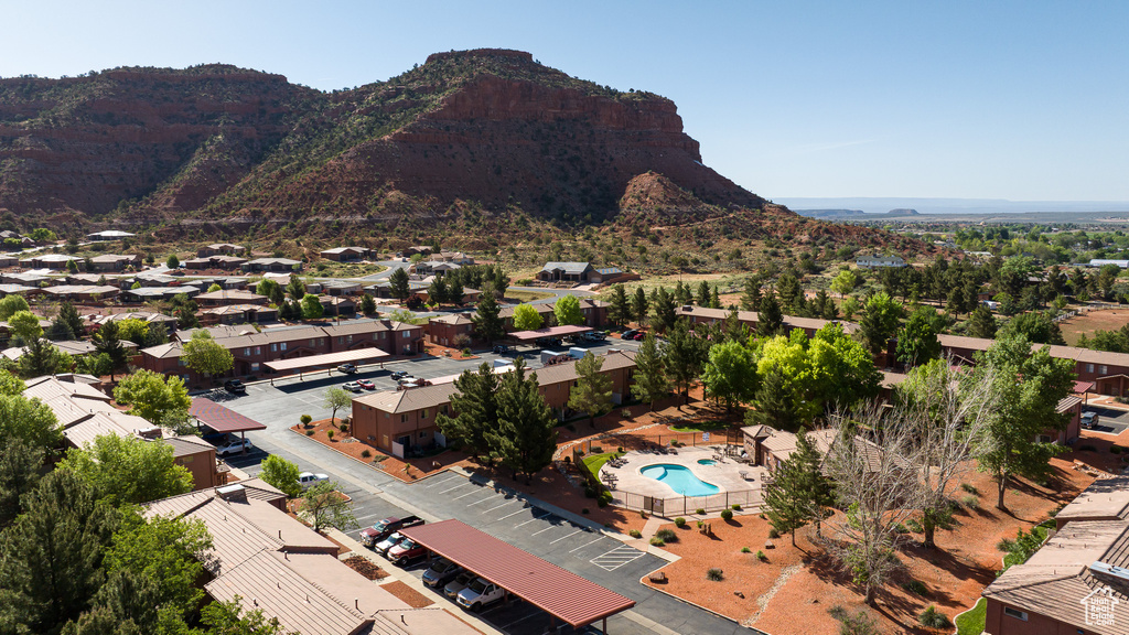 Aerial perspective of suburban area featuring a pool area and a mountain backdrop