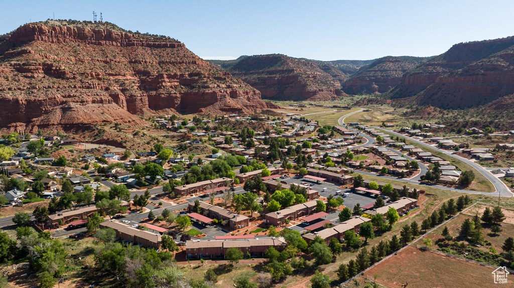 Aerial view of property's location featuring a mountainous background