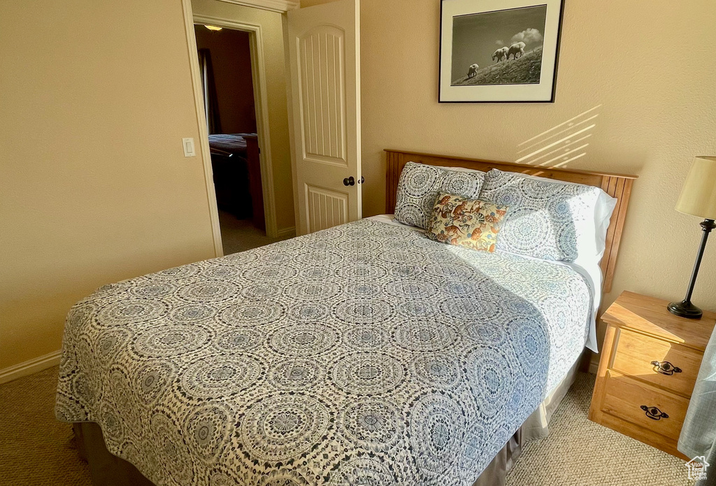 Bedroom with carpet floors and baseboards