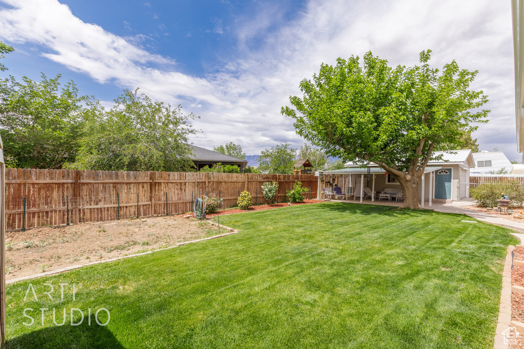 View of yard with a fenced backyard and a patio area