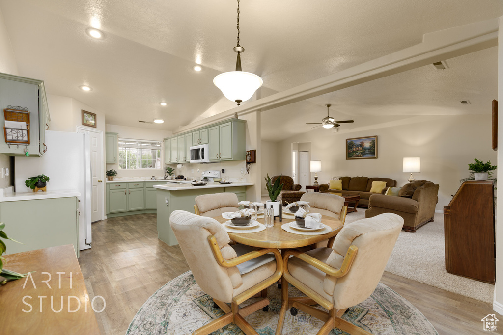 Dining room featuring visible vents, a ceiling fan, recessed lighting, light wood-type flooring, and vaulted ceiling