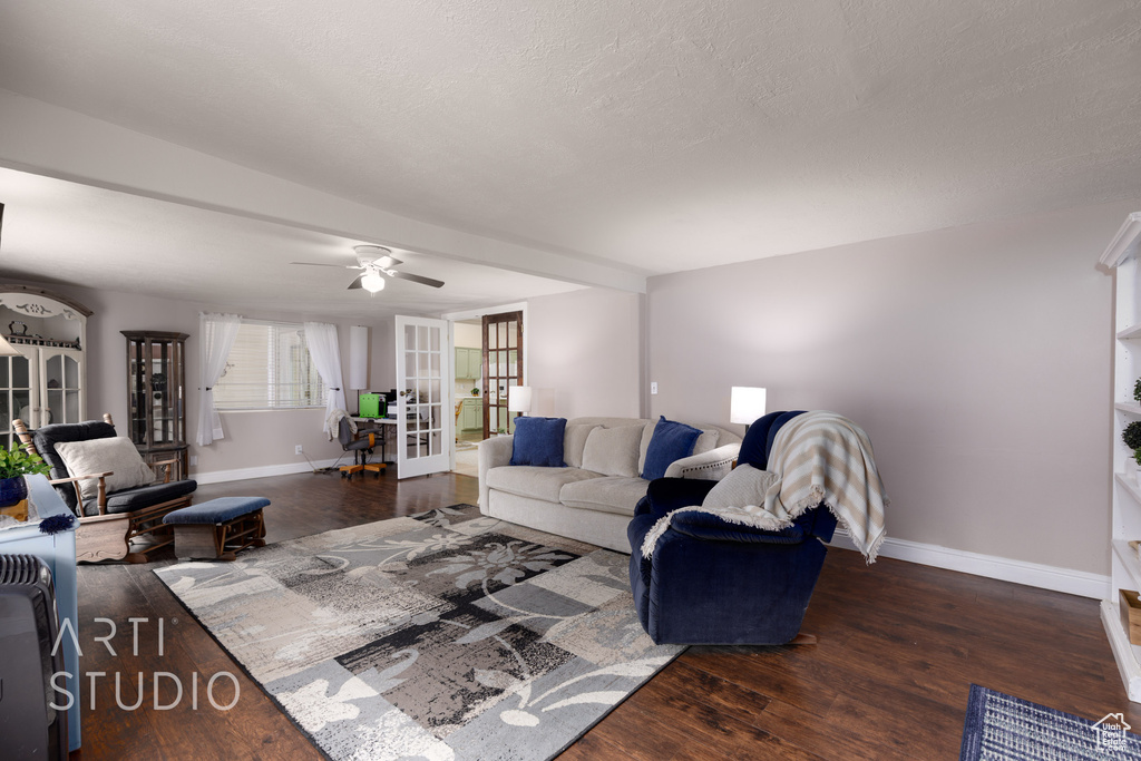Living area featuring french doors, baseboards, and wood finished floors