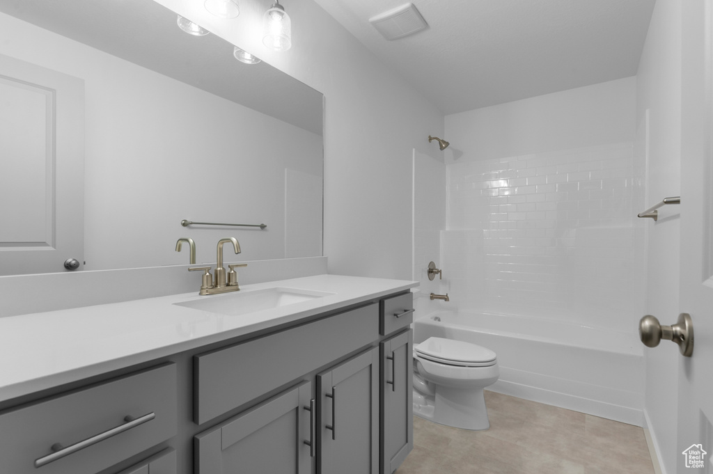 Full bath featuring vanity, bathtub / shower combination, and toilet