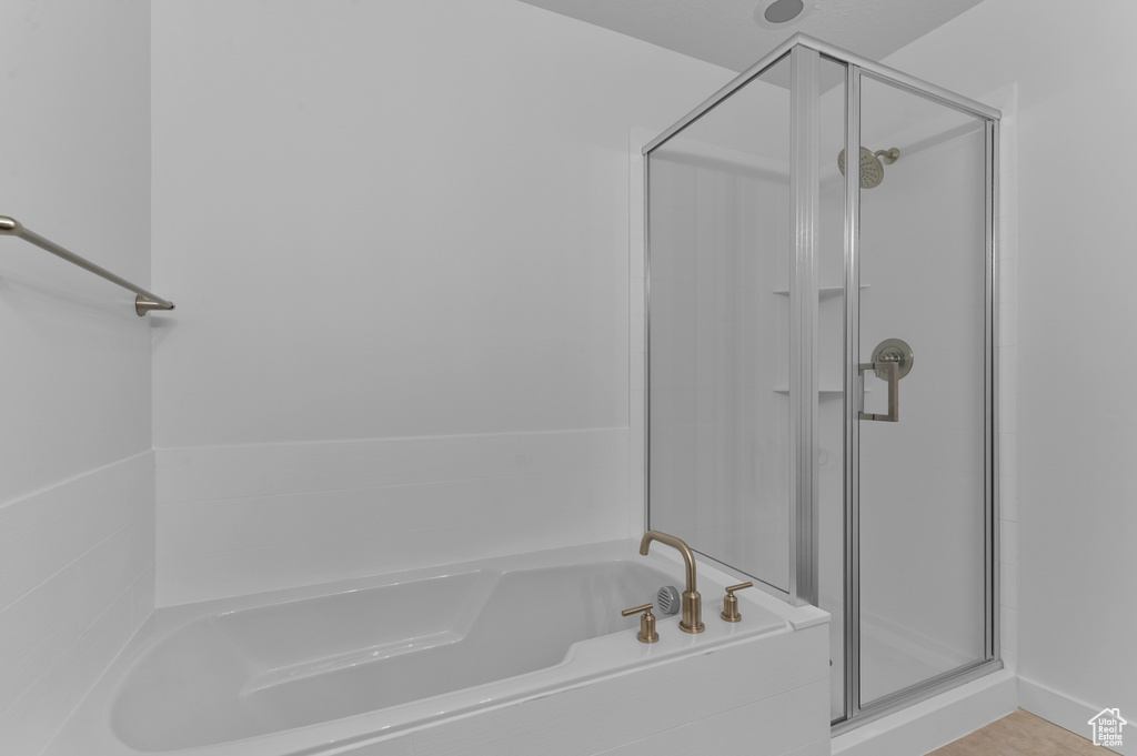 Full bathroom featuring a stall shower and a bath
