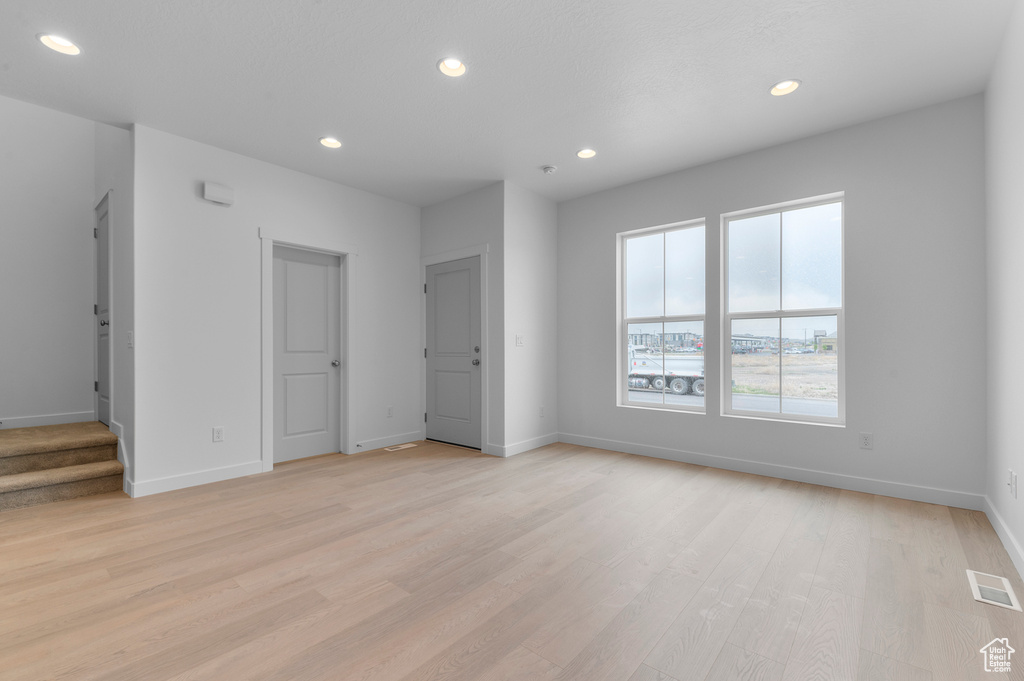 Interior space with visible vents, recessed lighting, baseboards, and light wood-style flooring