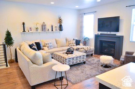 Living area featuring recessed lighting, a glass covered fireplace, and wood finished floors