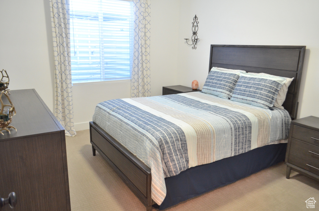 Bedroom with baseboards, multiple windows, and carpet flooring