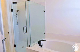 Full bathroom with a shower stall and a garden tub