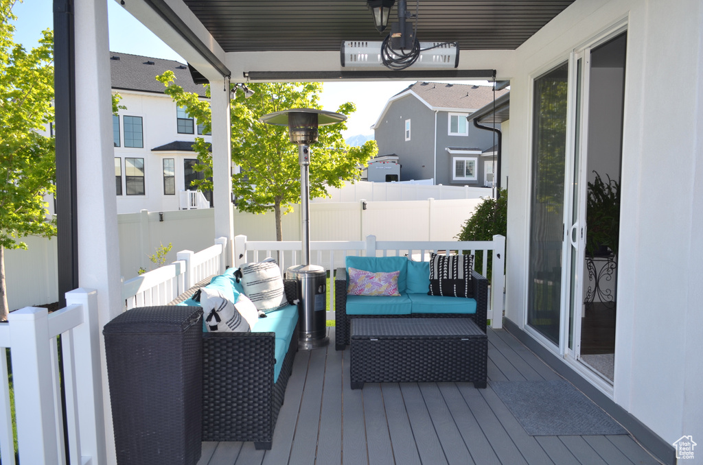 Wooden deck featuring fence and an outdoor living space