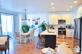 Kitchen featuring decorative light fixtures, tasteful backsplash, a sink, light countertops, and stainless steel appliances
