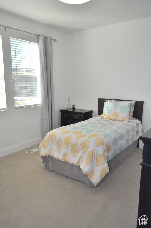 Bedroom featuring carpet floors and baseboards