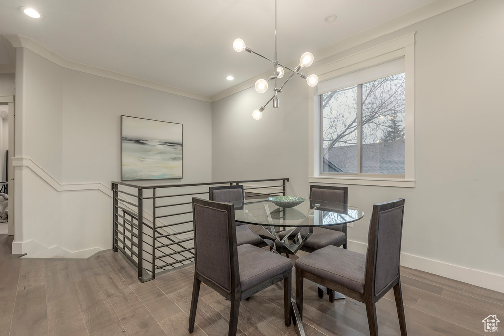 Dining space with baseboards, ornamental molding, recessed lighting, and wood finished floors