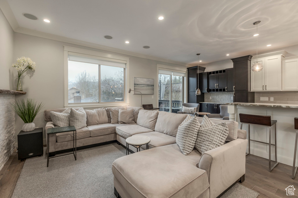 Living room with recessed lighting and light wood-type flooring