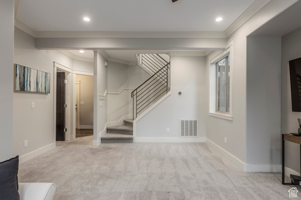 Unfurnished living room with recessed lighting, stairway, visible vents, and carpet
