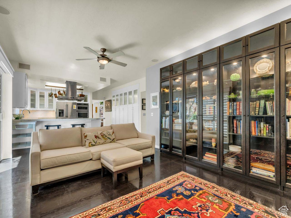 Living room featuring ceiling fan and visible vents