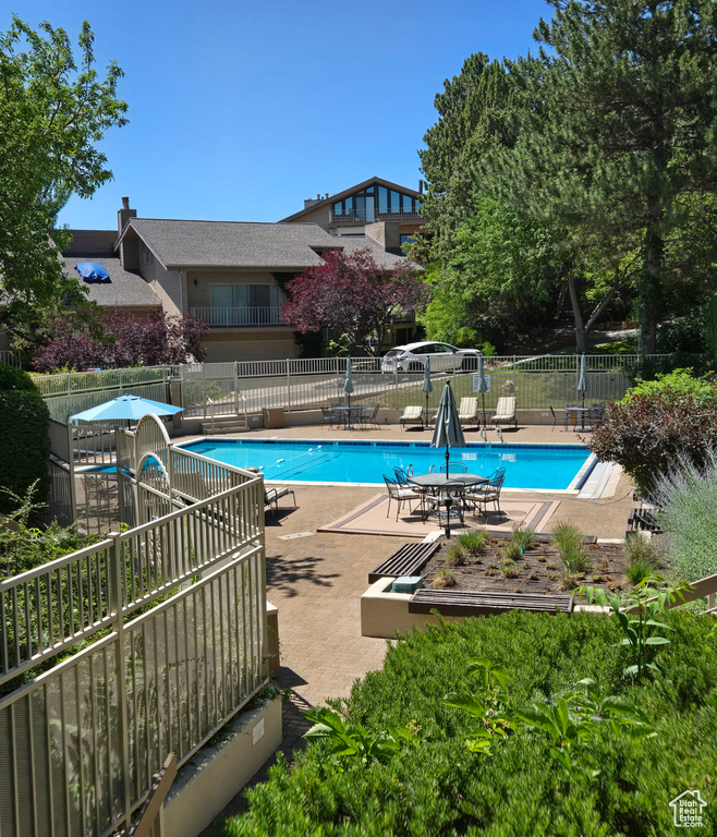 Community pool with a patio