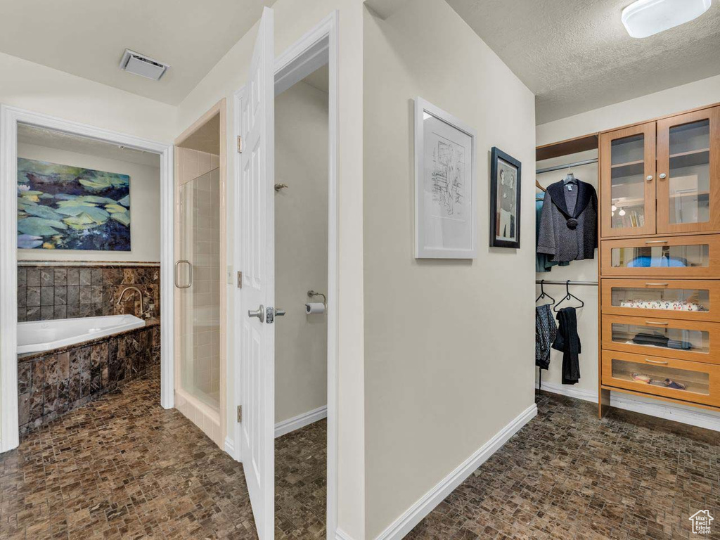 Hall with visible vents and baseboards