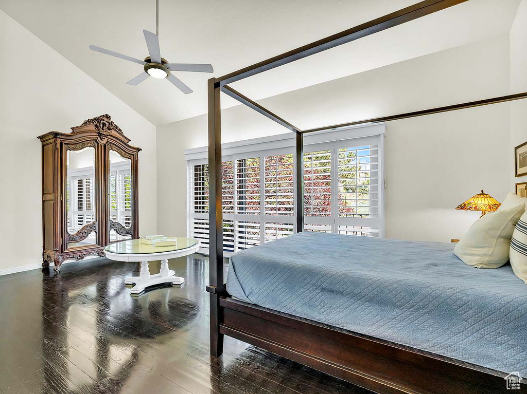 Bedroom with baseboards, lofted ceiling, wood finished floors, and ceiling fan