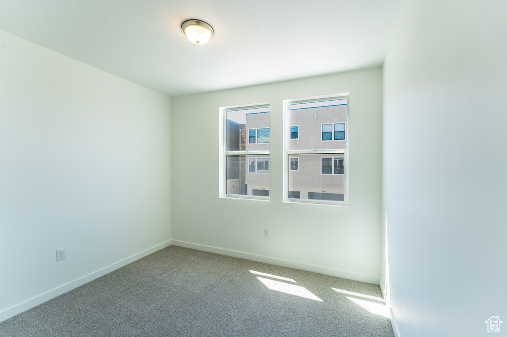 Empty room with carpet flooring and baseboards