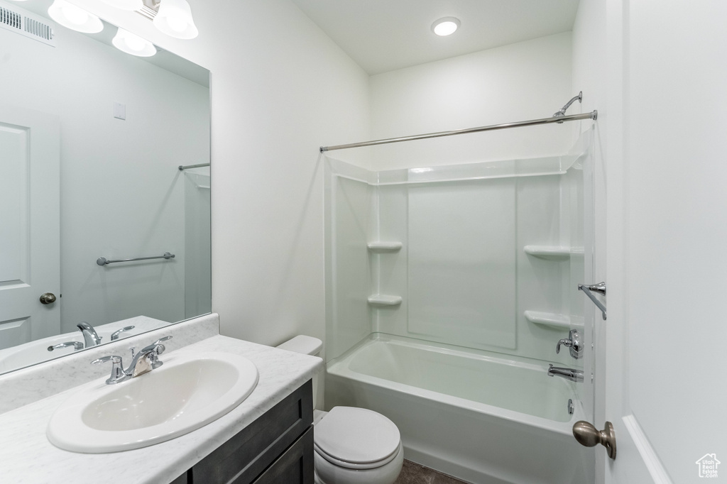 Bathroom with visible vents, shower / bathtub combination, toilet, and vanity