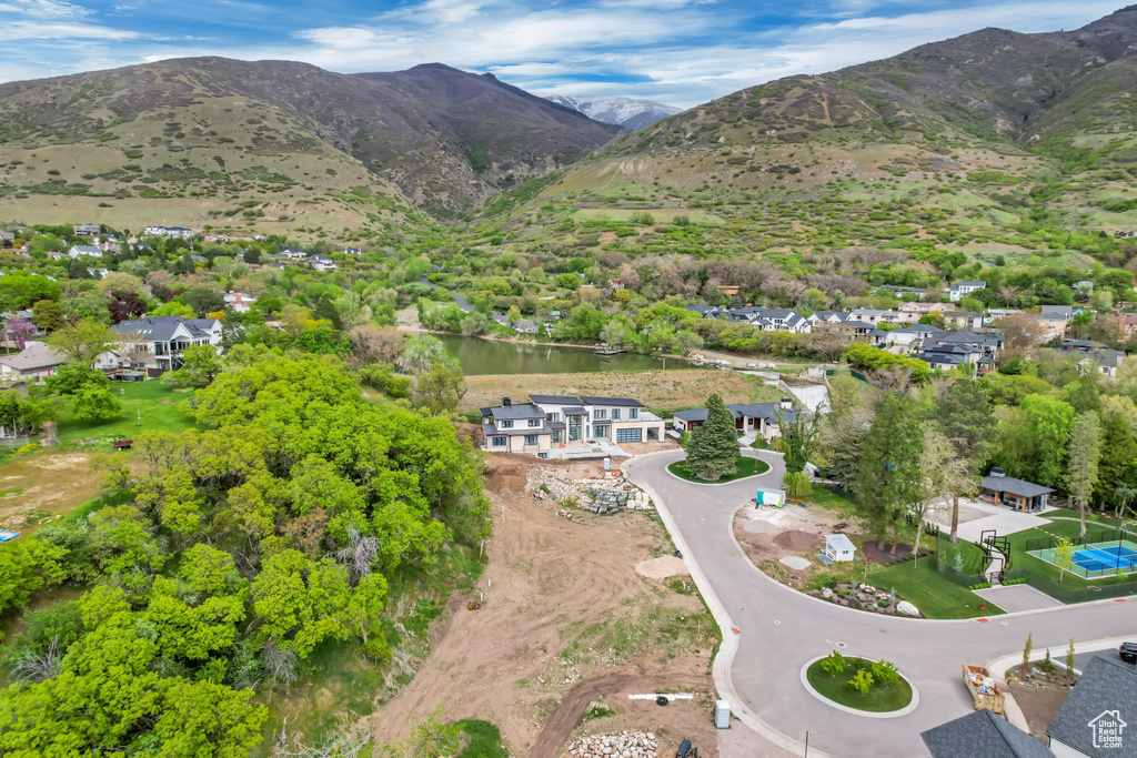 Drone / aerial view with a residential view and a water and mountain view