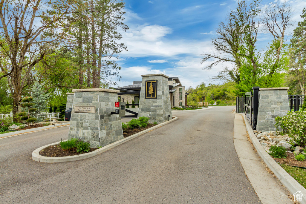 View of street with a gated entry and curbs