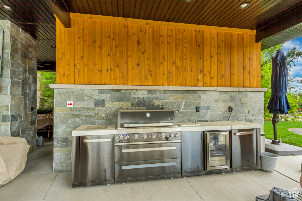 View of patio featuring beverage cooler and an outdoor kitchen