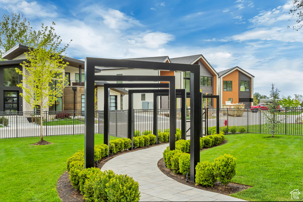 Surrounding community featuring a lawn and fence