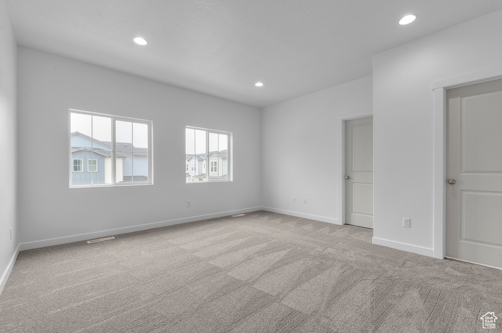 Unfurnished bedroom featuring recessed lighting, baseboards, visible vents, and carpet