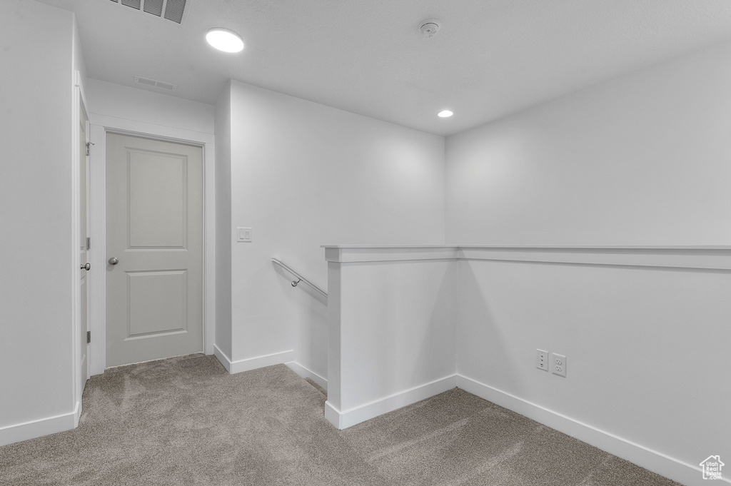 Walk in closet with visible vents and carpet
