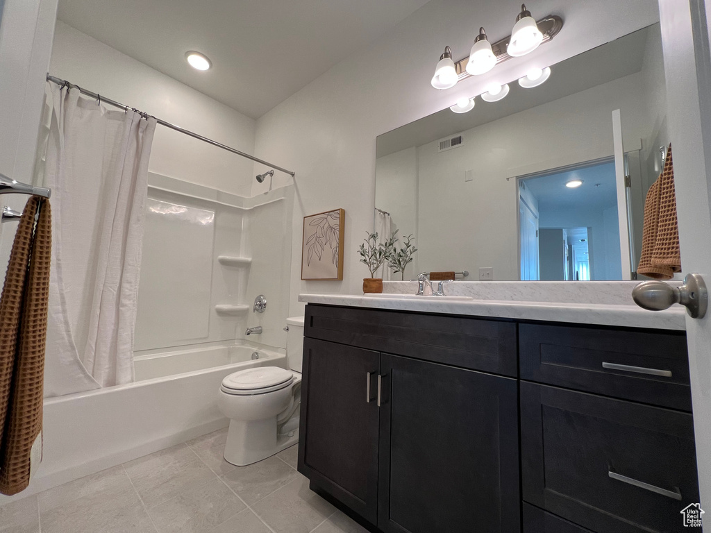 Bathroom with visible vents, tile patterned flooring, shower / bath combo, vanity, and toilet