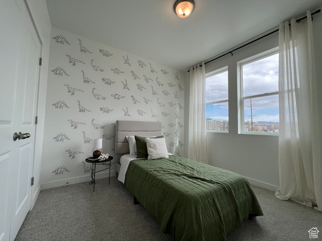 Bedroom featuring baseboards and light colored carpet