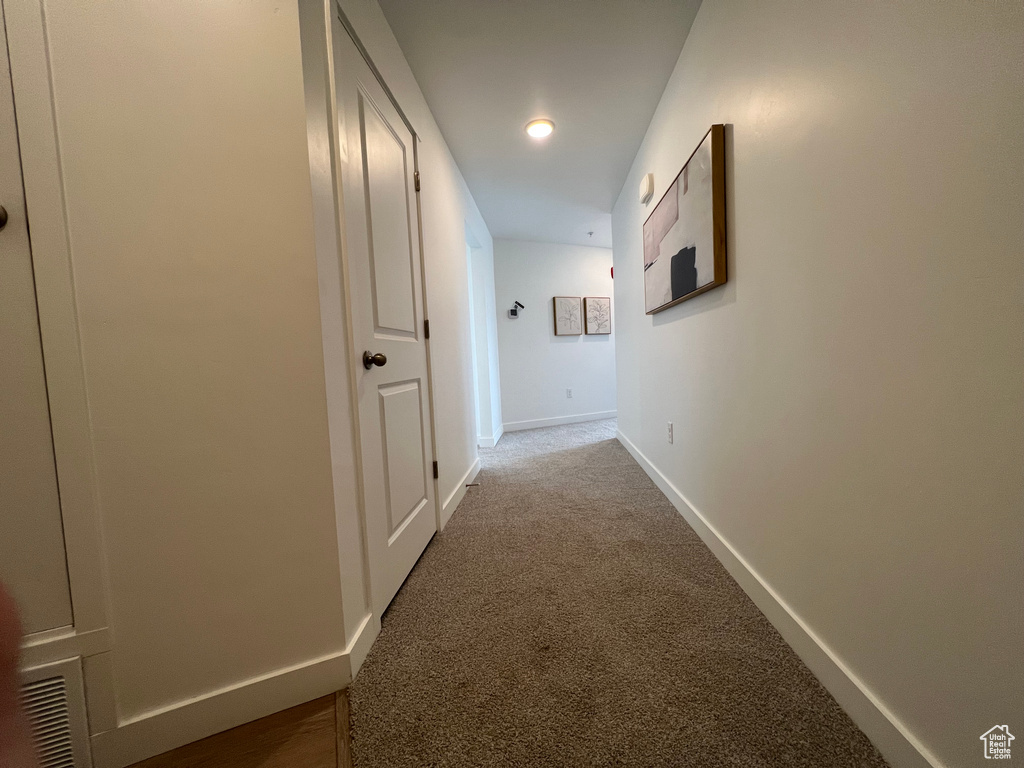 Corridor with carpet flooring, recessed lighting, baseboards, and visible vents