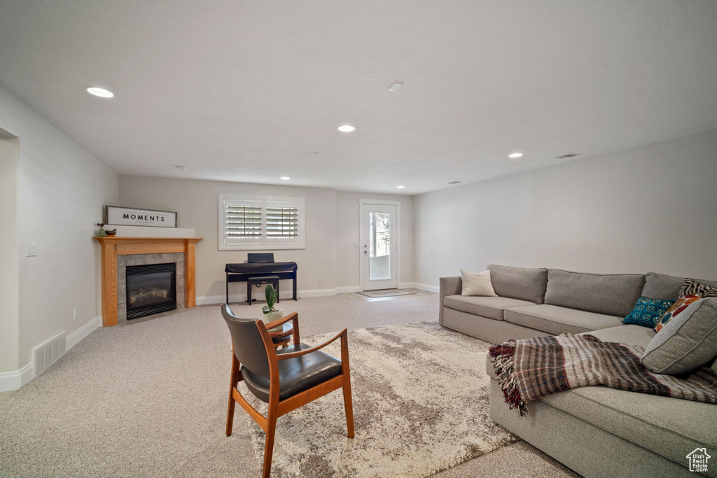 Living area featuring visible vents, recessed lighting, and carpet flooring